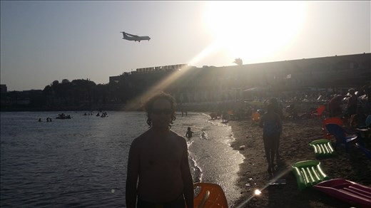 One of many beaches in Eilat, whilst a plane comes into land in the background.. 