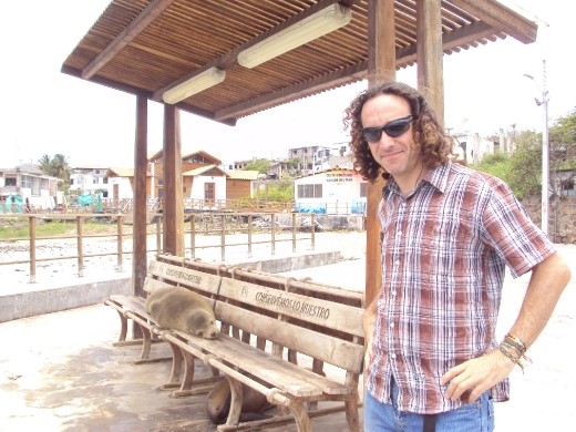 Myself, and a sea-lion on the bench. San Cristobal Island. The regulations of teh Islands are that one must keep two metres away from the animals. 