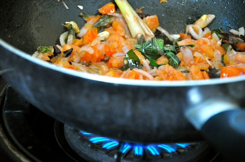 Sauteeing the tomatoes and onions until soft is important for the curry