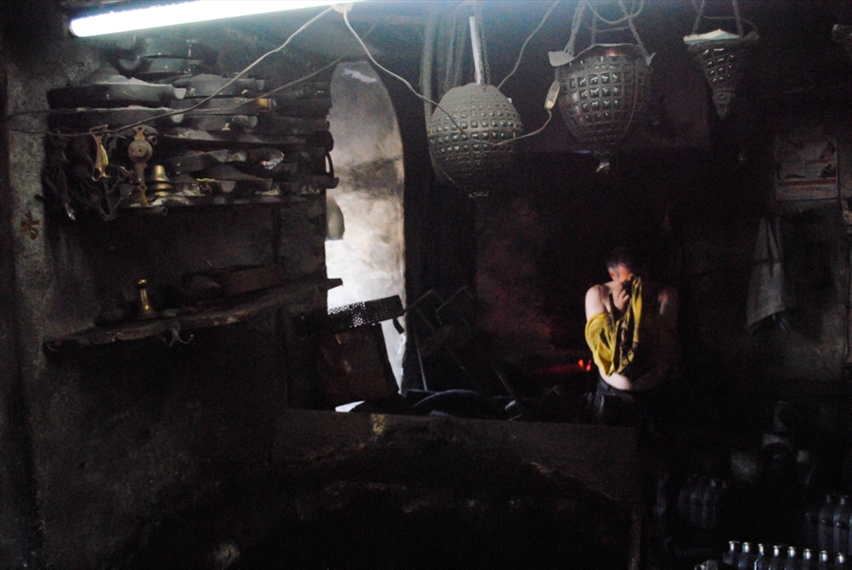 Tired from a days work casting bronze, he seeks a moments reflection. 