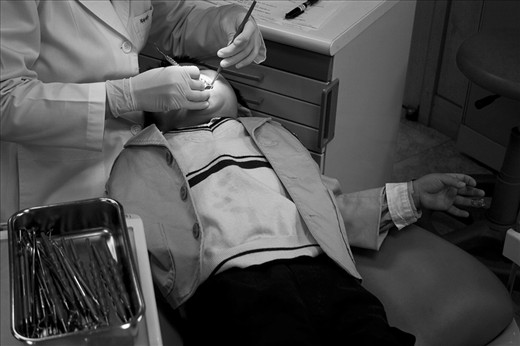A student undergoes a dental examination during a monthly field trip.