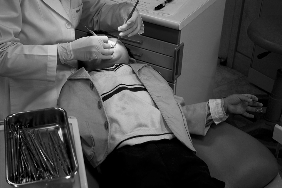 A student undergoes a dental examination during a monthly field trip.