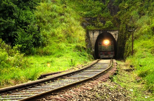 i was about 300m before tunnel when i heard the sound of the train and i ran with my camera and i saw the light of the train appearing through the tunnel and i did not have much time to set my exposure, but i did my best and zoomed full range up to 55mm with my kit lens.