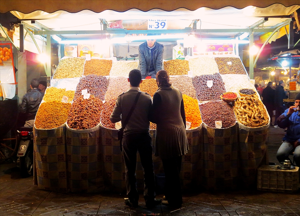 A couple browses the night market in Marrakesh.