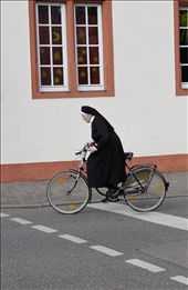 Nun on the run....A nun takes off pedaling after a stop light turns green.: by stacysimmering, Views[302]