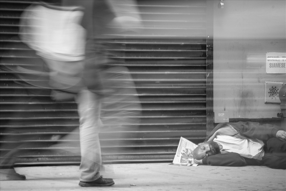 Sitting and catching my breath out side a shop that my wife loves I was watching this homeless man sleeping on the street. I noticed the people constantly walk past him and never once acknowledging him there. It made me sad but grateful for what I have. I took this photo to show how cold and naive people can be. (I was happy to give him some money and a bottle of water, he was thankful)