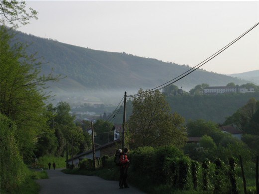 Pilgrims leaving St. Jean Pied-de-Port, France, on the last leg of the French Chemin de St. Jacques and the first leg of the Spanish Camino de Santiago, pause a moment to look back at the valley before turning their attention to the difficult climb up to the Col de Lepoeder and into Spain.