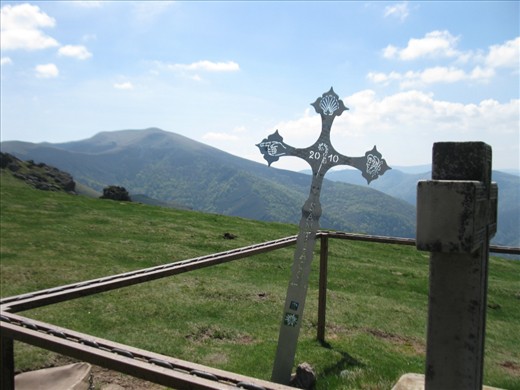 A few steps from the top of Col de Lepoeder, in the heights of the Spanish Pyrenees, a cross acting as route marker points your way forward to Santiago de Compostela, now roughly 775 kilometers away.  After this, just for today, it’s all downhill from here.
