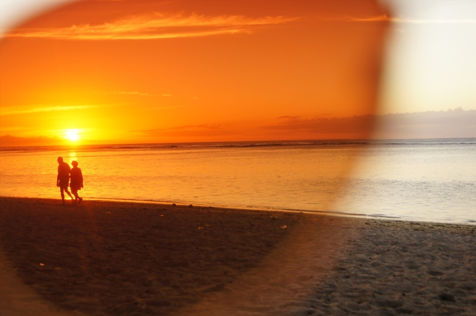 Through the view of my vintage aviators, the elderly couple takes a stroll along the endless shoreline hand-in-hand, chasing the sun.