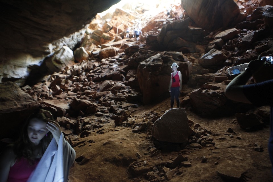 Tourist take photographs at the entrance of a cave in Chapada Diamantina.