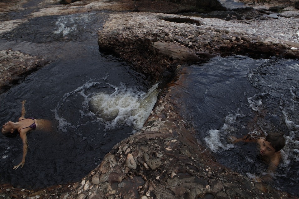 A mother and son in natural pools in the town of Lençóis in Chapada Diamantina.