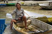 An older woman bails the water from her boat before going back out to harvest. There are almost no young people working in the seaweed farms anymore. They prefer to try to make easier money from the tourists. We watched many young men sit and watch as small elderly women struggle with heavy work. : by stephenbradley, Views[656]