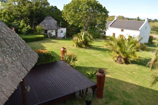 Hopefully this will help with the layout of the property. This is a shot from our balcony  in the main house at the back of the land. The deck area will be the tea rooms, the rondavel is on the left and Morley house cottage is towards the front. The pool is to the right of this shot.