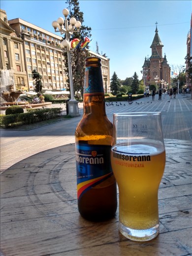 Enjoying the local brew, Timisoreana on Piata Victoriei.