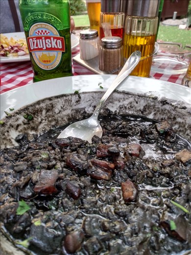 Tasting the local squid ink rice.