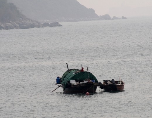 Fishing boat bobbing up and down on the water.