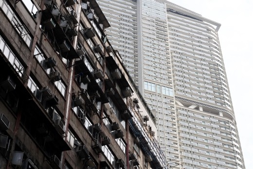 Contrast of the old public housing with a shiny new highrise at the rear