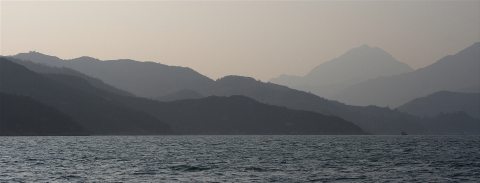 The murky hills lay testament to the air pollution in the area as the daylight is scattered.