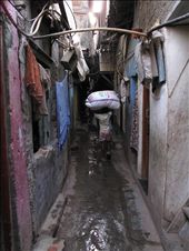 The lack of air and space is a leitmotiv here and the light is barely reaching the ground. It's not uncommon to see children working instead of being at school, like this kid carrying a package bigger than him.: by storytraveller, Views[1209]
