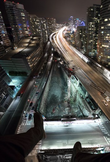 Buildings as far as the eye can see. We find ourselves gazing into the endless abyss. Light pours through the streets like a river through the concrete jungle.