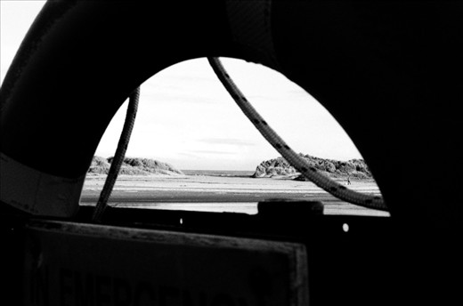 I love taking photos through objects, just to add depth to the photo.  Also this I love how the picture is contrasting between the black and white of the scene.