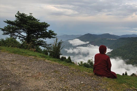 A monk is engaged in open air meditation.