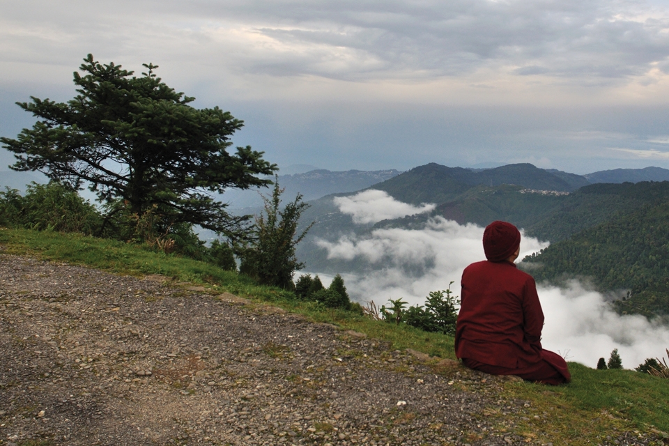 Meditation.A Buddhist monk is engaged in open air meditation in the abode of God
