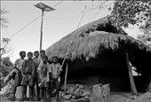 In the quaint hamlet of Huchukpara in Suri (Birbhum,West Bengal),  Sujoy (the boy with the unbuttoned shirt) and his friends proudly pose in front of his Solar powered house. The Solar Panel can be seen at the background on top of an improvised bamboo pole. In this remote village with no electricity, Solar energy is literally lighting up a lot of lives and smiles.: by sudhyasheel, Views[1278]