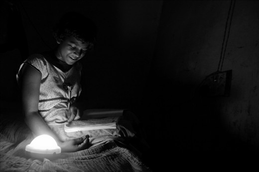 Seema studies at night under a solar charged lamp. She is confident that with the extra hours that she is putting in, she will give a tough competition to the students of other districts in the approaching board examinations. 