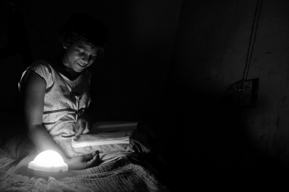 Seema studies at night under a solar charged lamp. She is confident that with the extra hours that she is putting in, she will give a tough competition to the students of other districts in the approaching board examinations. 
