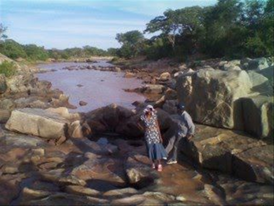 Two AE volunteers relaxing at the place where the water fall should be.