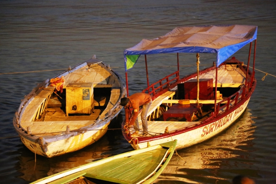 BOAT IS BEING FREED for boating .The boatmen dont charge a penny in allowing boating to these ascetic Naga people in hope of earning blessing from these holy men who appear at this Ghats/river bank once in 12 years.