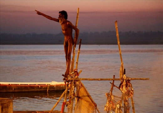 ASCETIC GIVING THE DIRECTION FOR BOATING AND HOLY  DIP to his fellow Nagas. This Ascetic Naga also showed his skill to walk nude on the sharp objects with no harm to him.