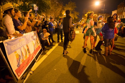 The competitors parade along the course of the Race while people take photos