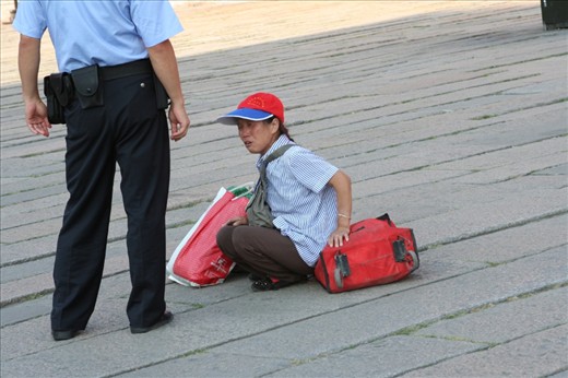 The cop and a lady in Tienman Square.  The lady was screaming.  According to my mom she was saying that her leg was broken.  Probably one of the many people trying to make money in the big city