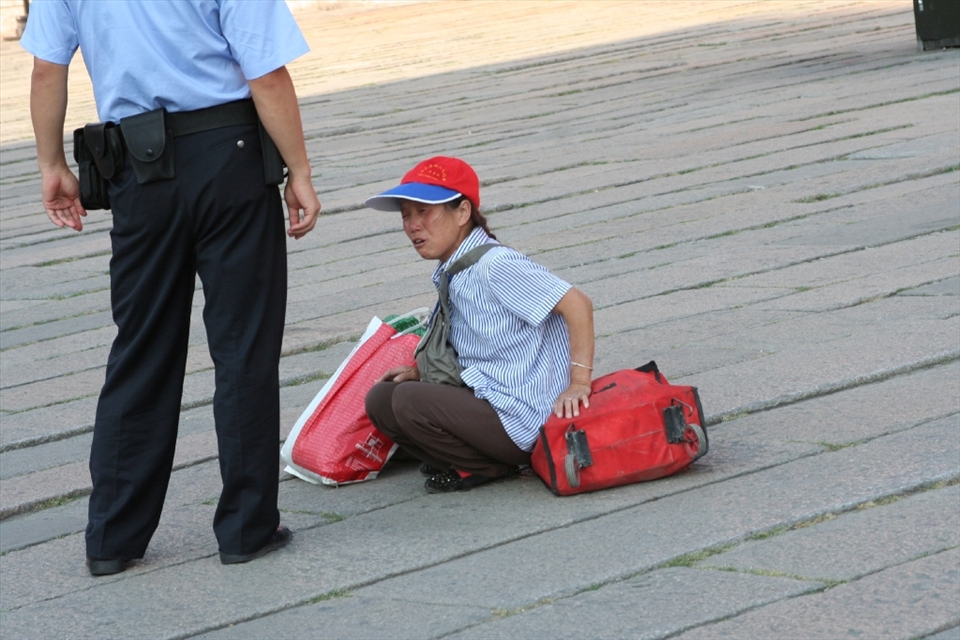The cop and a lady in Tienman Square.  The lady was screaming.  According to my mom she was saying that her leg was broken.  Probably one of the many people trying to make money in the big city