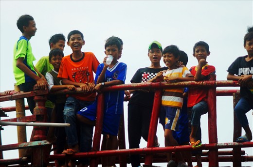 Children of the village Kampung Air which is next to the Sunda Kelapa port, hang out on the bridge. They have no open spaces to play in their village, but the open sea is the only playground. 