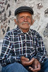 A beggar sits unnoticed amongst thousands of tourists as they flock to watch the sun set in Oia. : by sunnysantorini, Views[284]