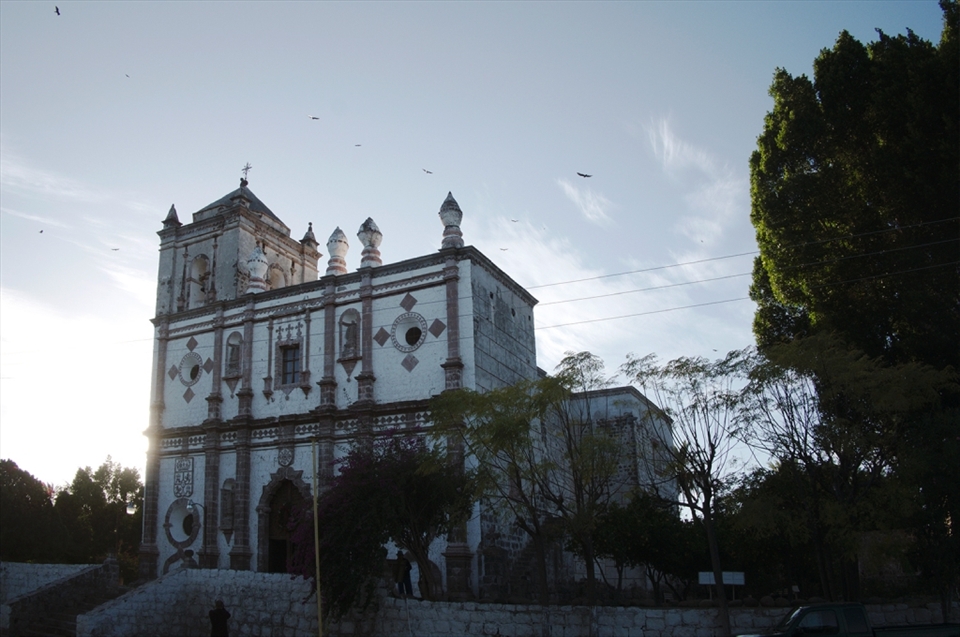 The Misión San Ignacio Kadakaamán, founded in 1728 by Jesuit Juan Bautista Luyando, springs upon the southbound traveler invisible until the last moment, bedded in a verdant arroyo amongst missionary date orchards. It is here that the trip to Palmarito begins in earnest, where the office of the Instituto Nacional de Anthropoleía e Historia connects the resident guide to the traveler. Every night at sunset vultures turn overhead working at the minds of Baja peoples in this difficult desert environs.