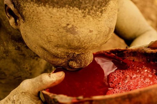 Local Suri 'Cowboy' drinking cow blood. Kibish, Southern Ethiopia