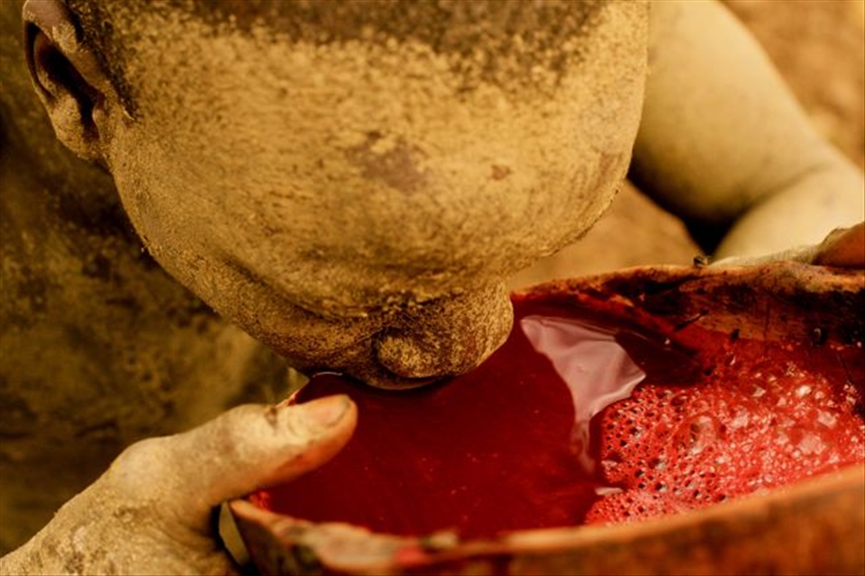 Local Suri 'Cowboy' drinking cow blood. Kibish, Southern Ethiopia