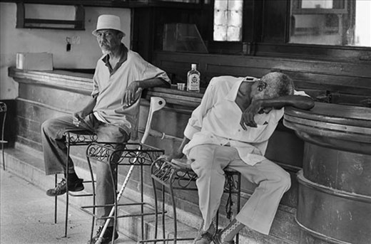 Elderly gents in a languid pose spend the afternoon in a Havana bar. Life since the US embargo has been full of hardship, particularly for the older generation.