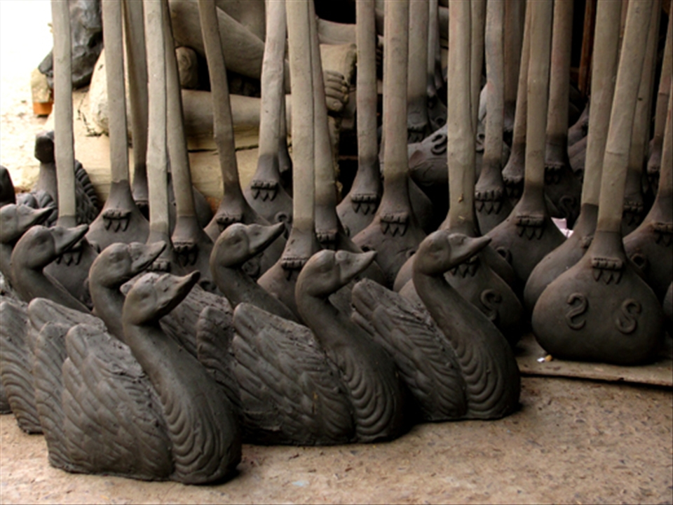 The Swan and the Veena are an integral part of the image of  Saraswati, the Hindu goddess of learning and wisdom. The veena is a string instrument on which she plays the music of life and love, while the swan signifies purity. Here a freshly made batch of swans and veenas have been set out to dry. Kolkata, India