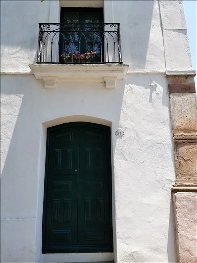 Beautiful old door and balcony -- reminiscent of New Orleans.