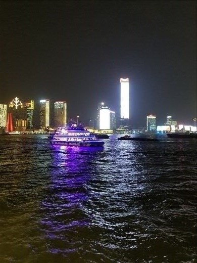 A leisure boat travels down the Huangpu River near the Bund.