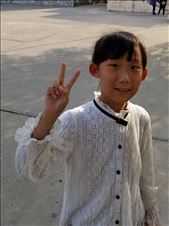 This girl and her mother were on the playground. I mimicked asking if I could take the girl's photo and, as was common with the kids, she gave a peace sign.: by suziqtn, Views[207]