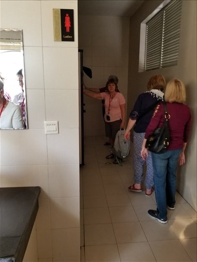 As we left, we had an opportunity to use the happy room. I guess because it was an elementary school, the doors didn't lock. And, here are the women all lined up, as usual.