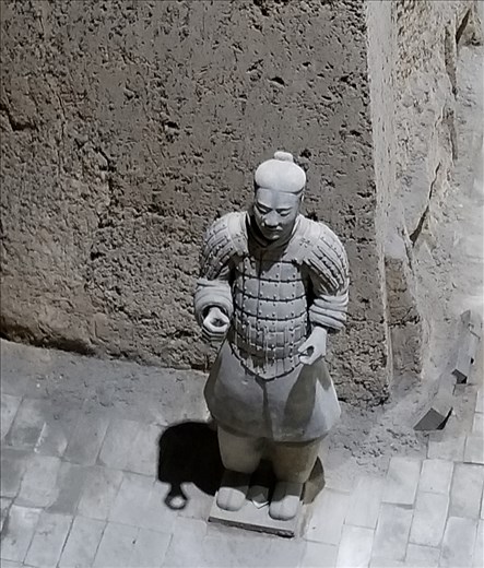 As you can see by the hands of this warrior, he was holding a weapon. They were made of wood, so also didn't survive.