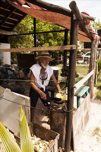 Jerry was selling coconuts from his tiny shack on the side of the road.