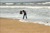 A boy juggling hard with his stuffs while protecting them from the sea waves.: by swati_choudhary, Views[255]